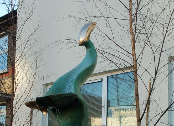 detail of the bronze sculpture The Gift by artist Sandra Bell. This is a bronze sculpture of an abstract figure