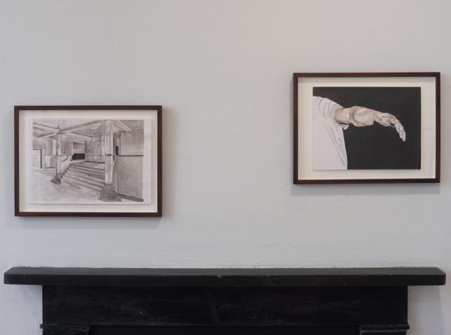A photo of two framed artworks on a wall