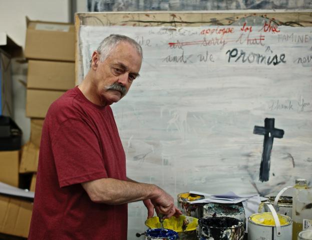 artist Patrick Graham painting in his studio