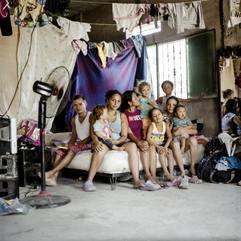 photograph of mother and children on a bed surrounded by lines of wasking