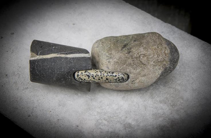 picture of a small stone sculpture. two rocks connected by a smaller rock